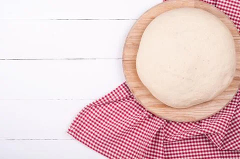 Dough for bread or pizza and kitchen towel on white rustic wooden backgroun.. Stock Photos