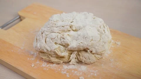 Dough for bread or pizza on a floured surface, with flour splash. Cooking bread 스톡 동영상 169389959