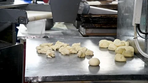 Dough for bread production in a bakery on an automated conveyor belt. Bread.. Stockbeeldmateriaal 237383865