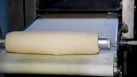 Dough for bread production in a bakery on an automated conveyor belt. Bread.. Video stock 239983338