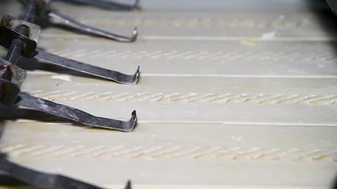 Dough for bread production in a bakery on an automated conveyor belt. Bread.. Видео 239983350
