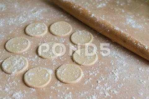 Dough circles and rolling pin Stock Photos