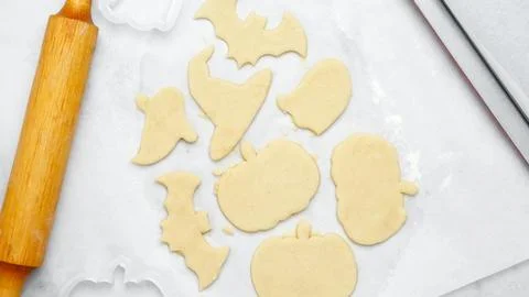 Dough with cookie cutter. Making different shapes of fall cookies for Hallowe Stock Photos