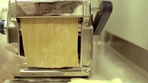 Dough Cutting Machine. Cutting Dough With Machine. Machine Cuts  Dough for Pasta Stock Footage 82168616