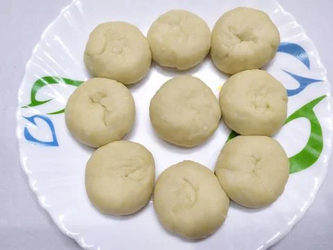 A dough divided into small balls for making luchis Stock Photos