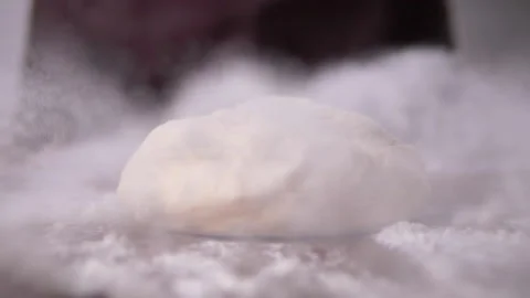Dough drop into floured in slow motion Stock Footage 138288564