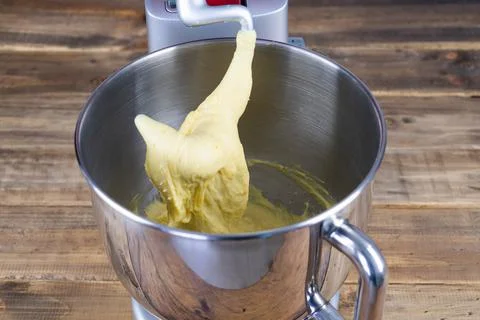 Dough elaboration process with kneading machine. Bakery concept. Stock Photos