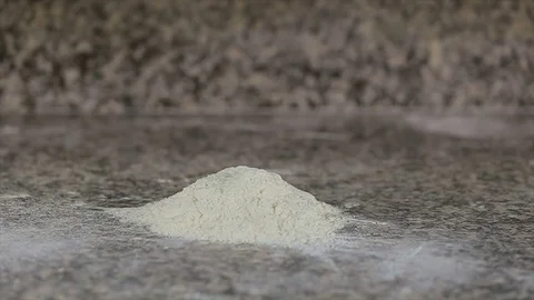 Dough falls onto the floured table Stock Footage 72983847