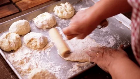 Dough flattened with rolling pin stretched for pizza or calzone by senior chef Stock-Footage 149282902