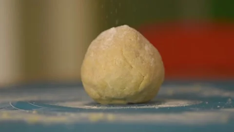 Dough of flour and egg that is covered with a shower of flour Stock Footage