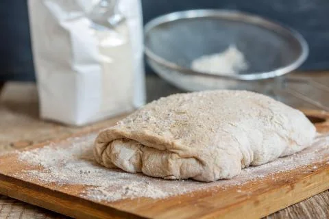 Dough on a floured table. Stock Photos