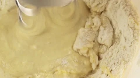Dough ingredients being mixed with dough hooks Stock Footage 24673210