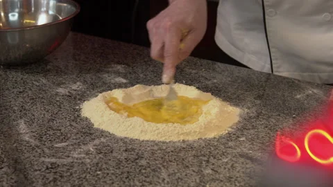 Dough kneading process. The chef mixes the egg with flour Stock Footage 151038787
