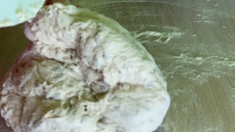 Dough kneading. Process the dough for wheat bread with seeds. Female hands Video stock 124947837