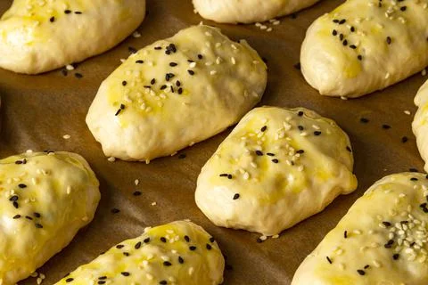 The dough is laid before baking on a baking sheet in the oven Stock Photos