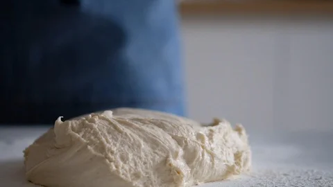 Dough lies on the table and moves. Production of bread from the dough Video stock 128254793