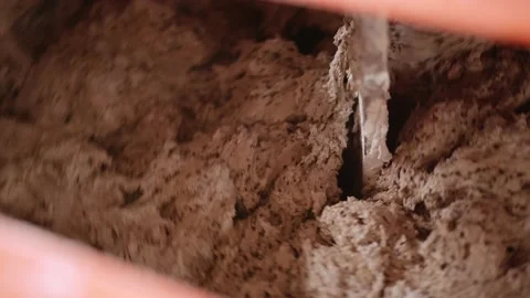The dough is mixed in a bowl to make bread at the bakery Video stock 143980520