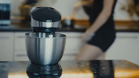 Dough mixing machine on desk in kitchen. Ingredients mixing steel bowl Woman Stock Footage 78033585