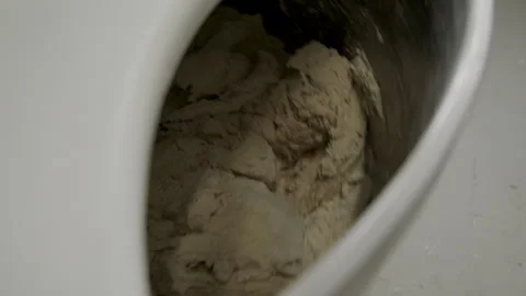 Dough mixing process in a kitchen during the day with a focus on mixing Stock Footage 345031522