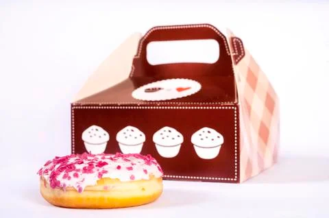 Dough-nut in front of box Stock Photos