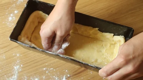 The dough is placed in a baking dish. Stock Footage 115210955