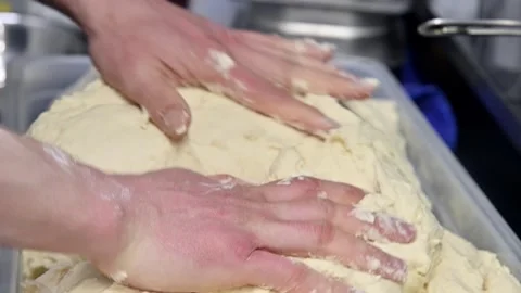 Dough preparation process with hands kneading and shaping in kitchen setting Stock Footage 336677395