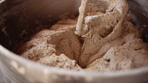Dough prepared for baking bread in an iron bowl at the bakery Stock Footage 143980587