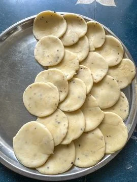 Dough rolled out in circular shapes called mathri made out of whole wheat f.. Stock Photos