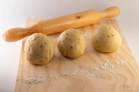 Dough on a rolling board with a rolling pin Stock Photos