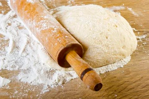 Dough with rolling pin Stock Photos