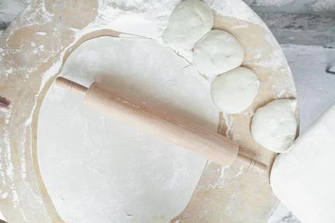 Dough with rolling pin on table. Stock Photos