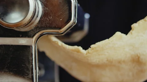 Dough rolls out of pasta rolling machine Stock Footage 274612502