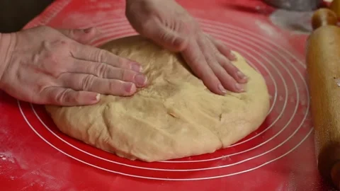 Dough shaping by hands on baking mat during bread making. Видео 332409011