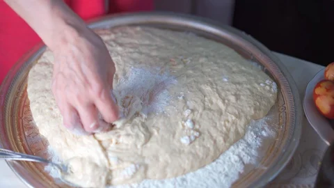 Dough sprinkled with flour for making buns Stock Footage 129516512