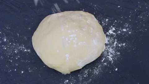 Dough sprinkled with flour top view close-up Stock Footage 122189946