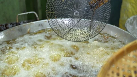 Dough sticks on boiling deep fat oil, asian street food, cooking doughnuts Stock Footage 71392362