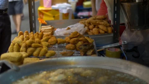 Dough sticks on boiling deep fat oil, asian street food, cooking doughnuts Stock Footage 71392491