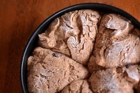 The dough on a tray on the table is ready for baking. Stock Photos