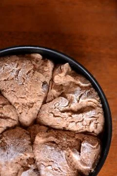 The dough on a tray on the table is ready for baking. Stock Photos