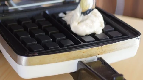 Dough for waffles in a waffle iron Stock Footage 85980942