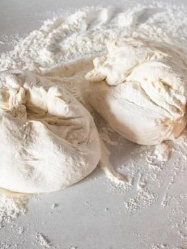 Dough on a white table with flour. Stock Photos