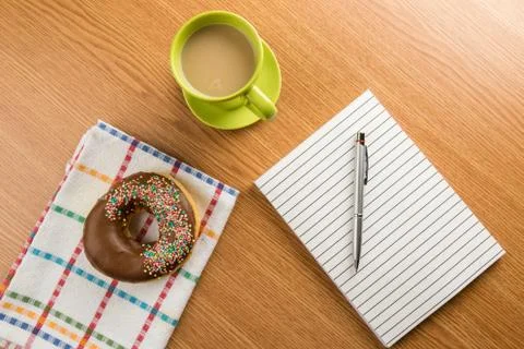 Doughnut coffee and notepad with pen Stock Photos