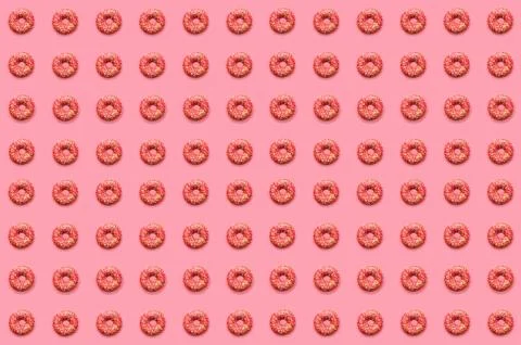 Doughnut pattern. Thel pattern of pink doughnuts lay flat on a pink backgroun Stock Photos