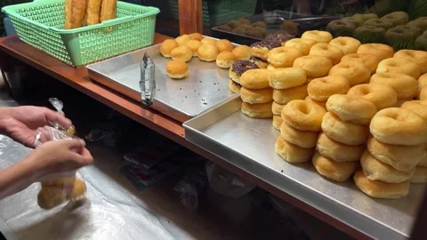 Doughnut store preparing doughnut in a plastic bag Stock Footage 274040854