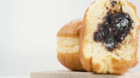 Doughnuts with chocolate on a white background, donut bite mark. Delicious sweet Stock Footage 143799452