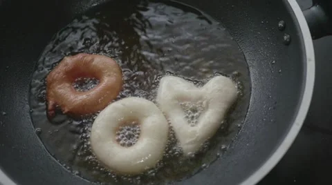 Doughnuts fried in big pan Stock Footage 60658298