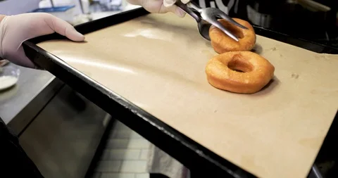 Doughnuts preparation, chocolate and chopped hazelnuts Stock Footage 129712554
