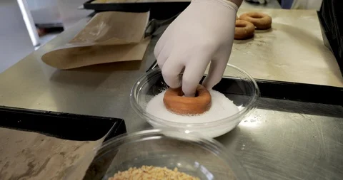 Doughnuts preparation, chocolate and chopped hazelnuts Stock Footage 129712565
