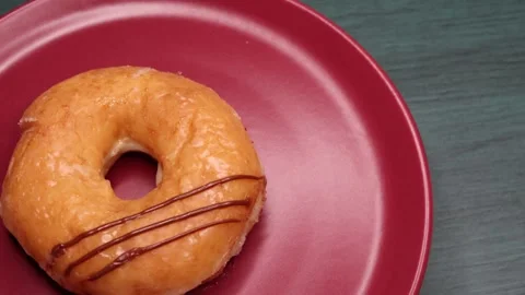 Doughnuts That Rotate 360 Degrees on the Plate Stock Footage 248572786