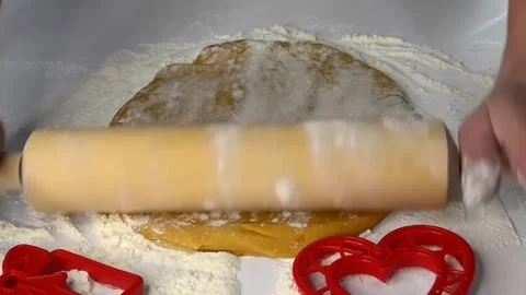Dought, rolling pin and cookies cutters shape heart Stock Footage 145182577